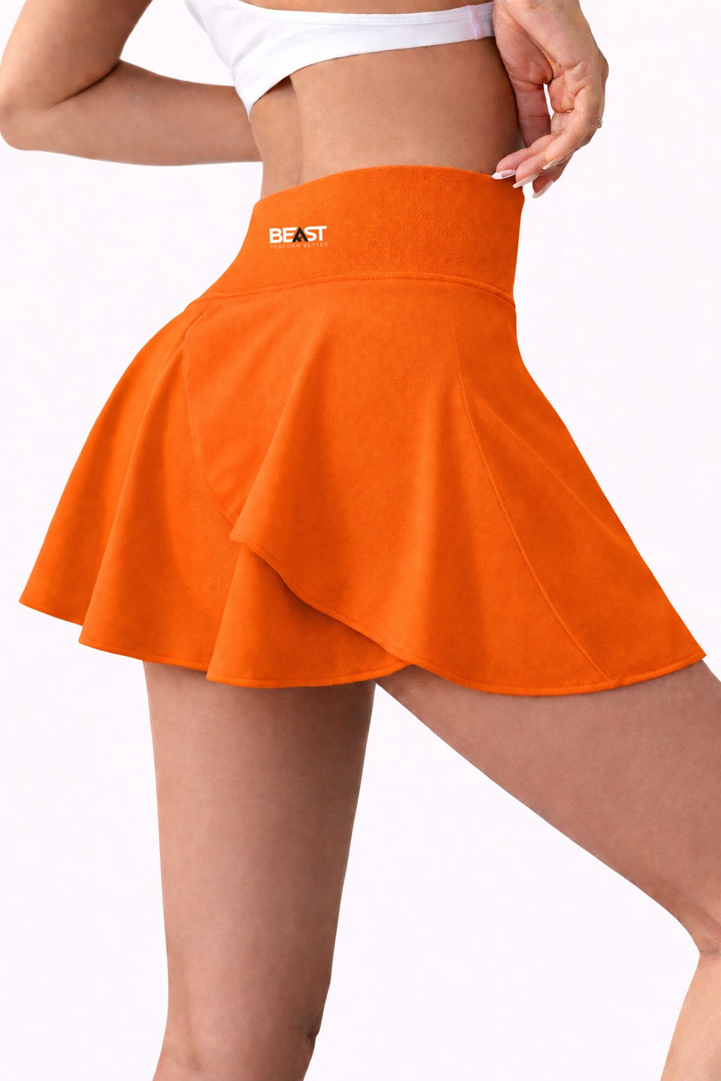 Orange skirt with 'BEAST' logo worn by a person on a white background